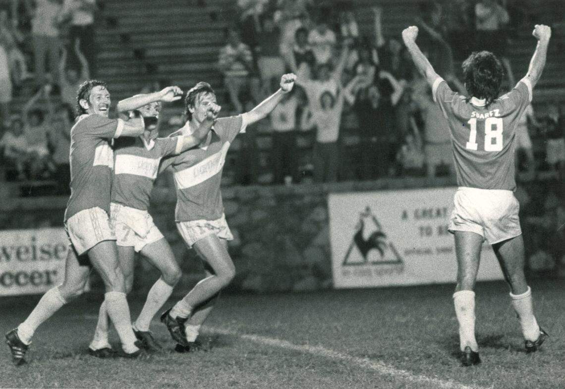 Tony Suarez (18) celebrates with several of his Carolina Lightnin’ teammates in the early 1980s.