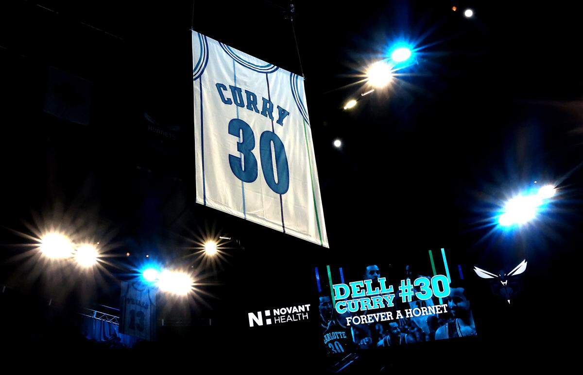 Former Charlotte Hornets forward Dell Curry's jersey number banner is raised into the rafters of the Spectrum Center during his jersey retirement ceremony on Thursday, March 19, 2026. The Charlotte Hornets retired Dell Curry's number 30 jersey and lifted a banner into the rafters during half time of the team's game against the Orlando Magic.