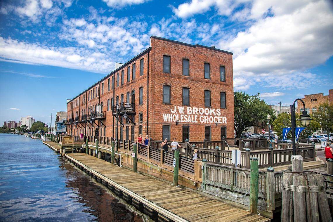 A family walks the Wilmington, North Carolina, Riverwalk closest to the old J.W. Brooks Wholesale Grocer building. In the movie “Scream” (2022), you can see the Riverwalk in the trailer, when Sidney answers a phone call.