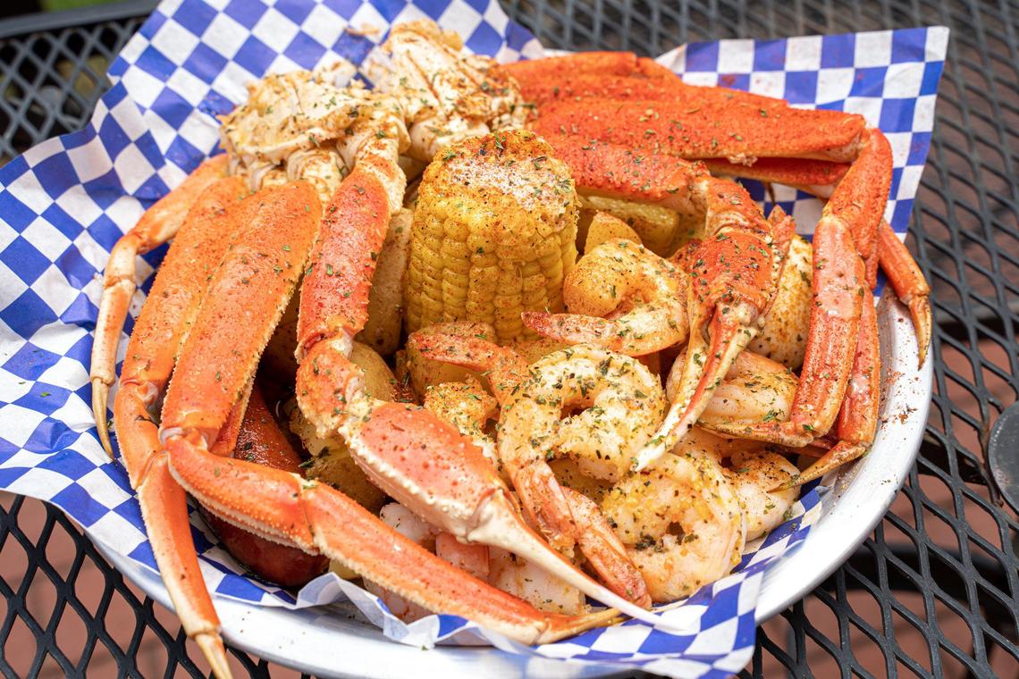 Krustaceans’ Crab & Shrimp Platter is served in a butter bath with sausage, potatoes, corn and a hard-boiled egg.