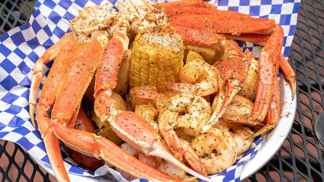 Krustaceans’ Crab & Shrimp Platter is served in a butter bath with sausage, potatoes, corn and a hard-boiled egg.