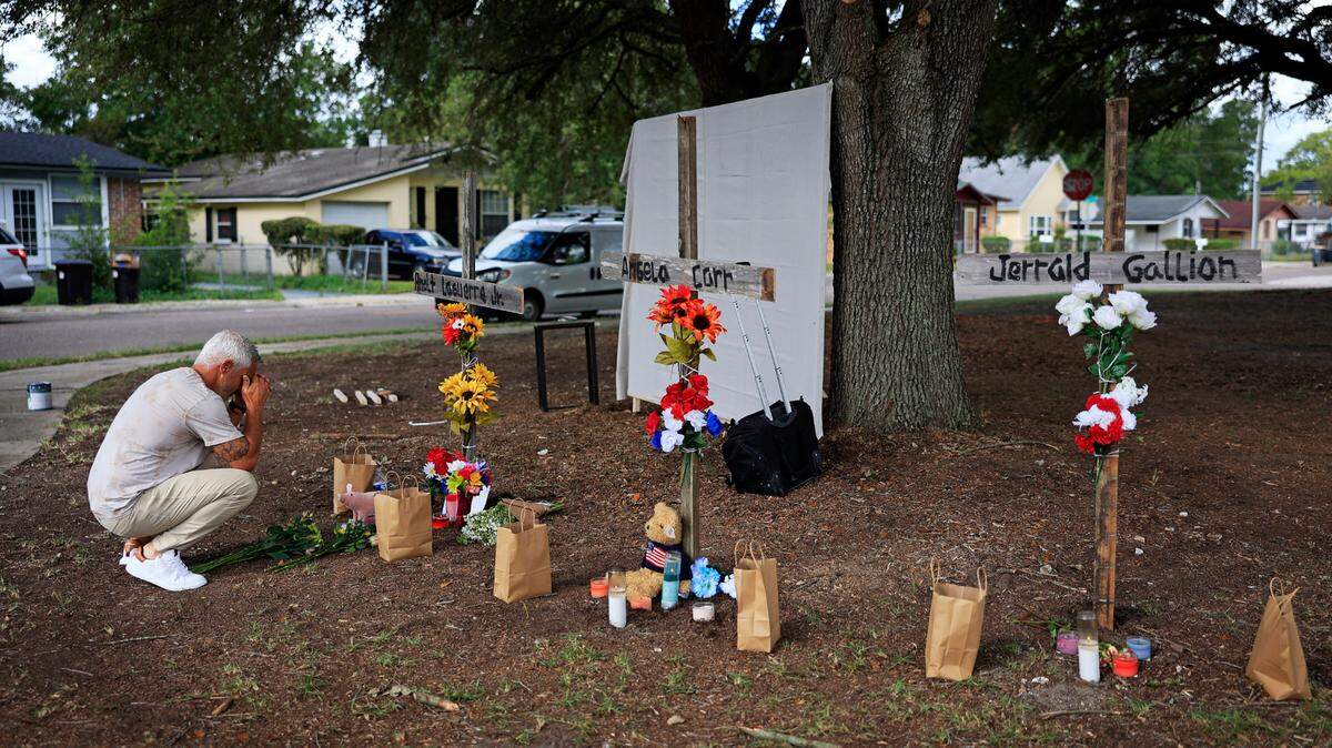 Will Walsh, of Nocatee, Fla., prays in front of crosses honoring the three Black people killed on Aug. 26, 2023 during a racially motivated shooting at the Dollar General store in Jacksonville, Fla.