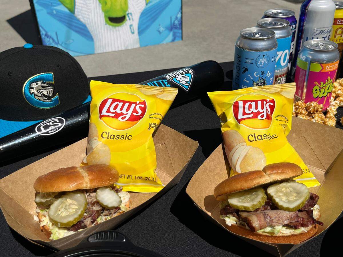 Barbecue pork and brisket sandwiches with house-made pickles on a brioche bun at Truist Field.