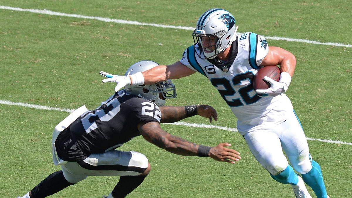 Carolina Panthers running back Christian McCaffrey, right, reaches out to knock Las Vegas Raiders cornerback Keisean Nixon, left, aside on a run during third quarter action on Sunday, September 13, 2020 at Bank of America Stadium in Charlotte, NC. The Raiders defeated the Panthers 34-30.