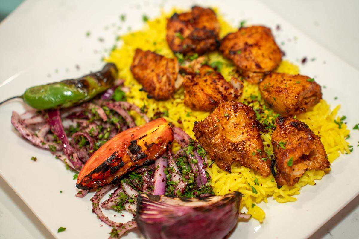 Chicken Kebab with house seasonings and vegetables and yellow rice at Roz Grill.