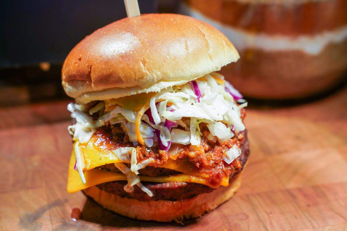 Bank of America Stadium’s Carolina burgers come with with brisket chili, slaw, onions and mustard.