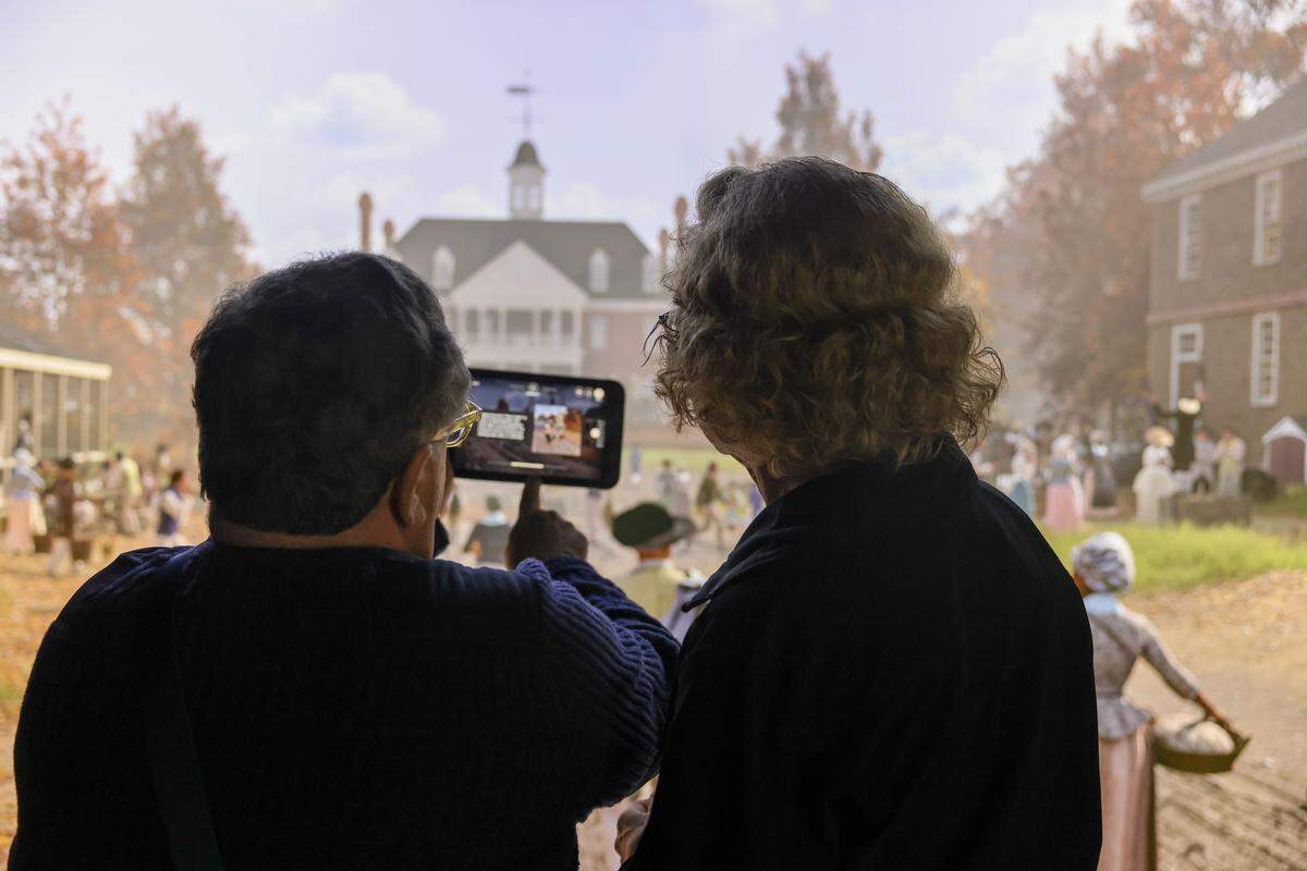 Michael Solender, left, and Harriet Meetz view the “American Revolution: The Augmented Exhibition” during a preview Tuesday, April 7, 2026, at the Charlotte Museum of History.