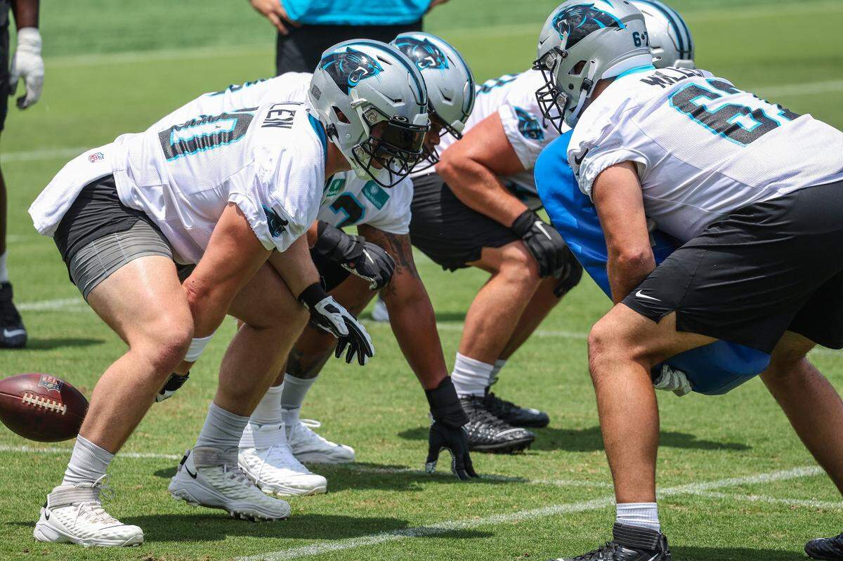 Panthers tguard Pat Elflein, left, hikes the ball during individual position drills on day two of mini camp on Wednesday, June 15, 2022 in Charlotte, NC.