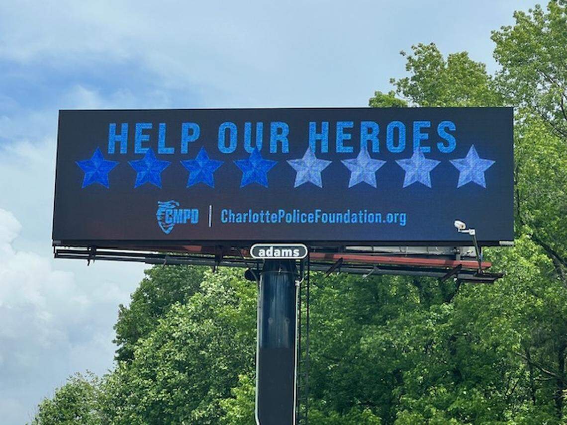 Adams Outdoor Advertising had put up billboards throughout Charlotte that read “Help Our Heroes” with four dark blue and four light blue stars representing the eight officers killed and wounded while serving a warrant on Monday.