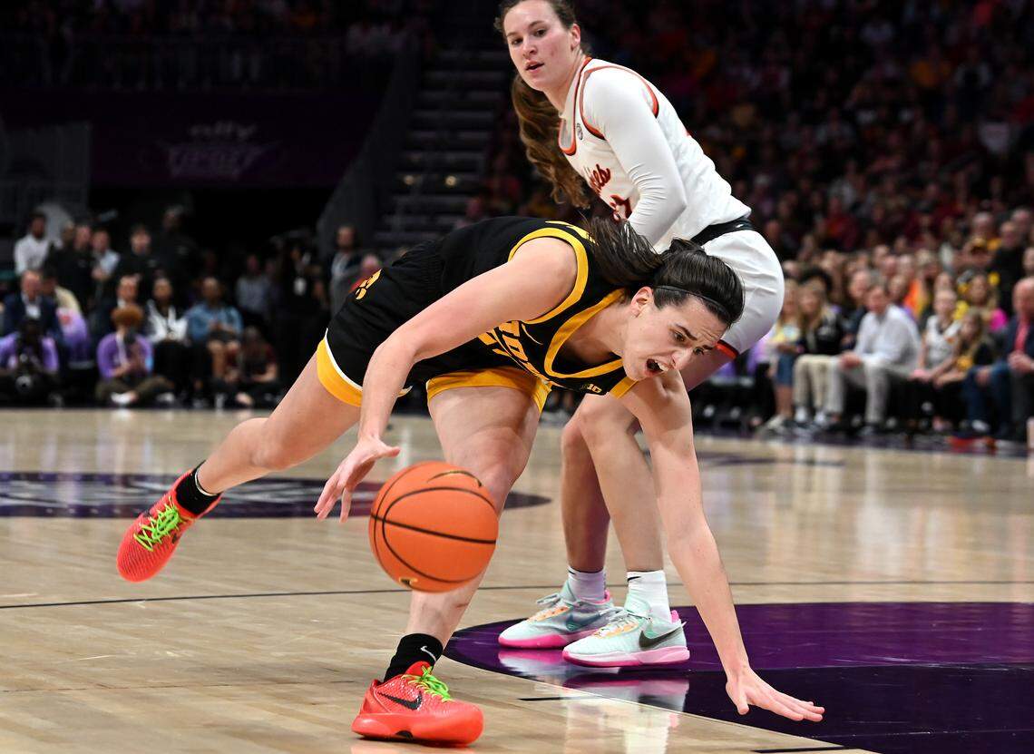 Iowa’s Caitlin Clark fights to keep her balance as she drives to the basket during first-half action against Virginia Tech on Thursday, November 9, 2023 at Spectrum Center in Charlotte, NC.