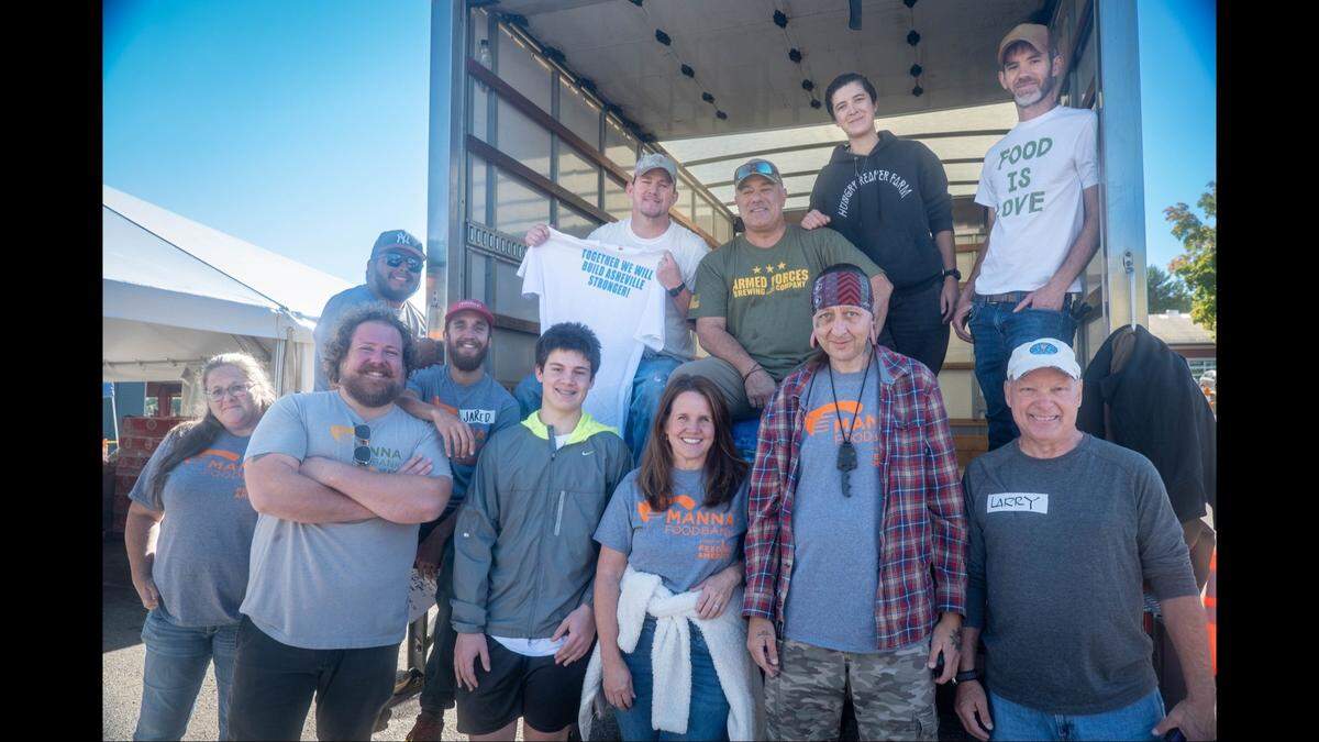 Actor Channing Tatum, far left in top row, shocked Tropical Storm Helene relief volunteers with an unannounced visit to an Asheville food bank on Wednesday, Oct. 16, 2024.