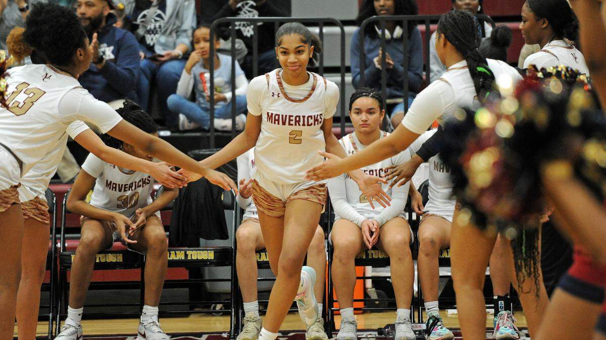 Mallard Creek’s My’Asia Young, center, exchanges high fives with her teammates during pre-game introductions for the Queen City 3A/4A tournament girls championship game against North Mecklenburg on Friday, Feb. 23, 2024, at Harding University High School in Charlotte, N.C. (CREDIT: BILL KISER/SPECIAL TO THE OBSERVER)