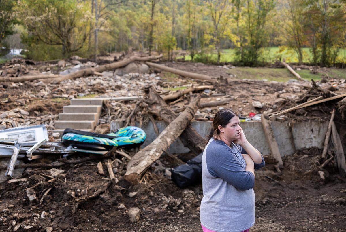 Kelli Ball stands in the area next to her home where a landslide came through in Barnardsville, N.C. on Wednesday, October 2, 2024.
