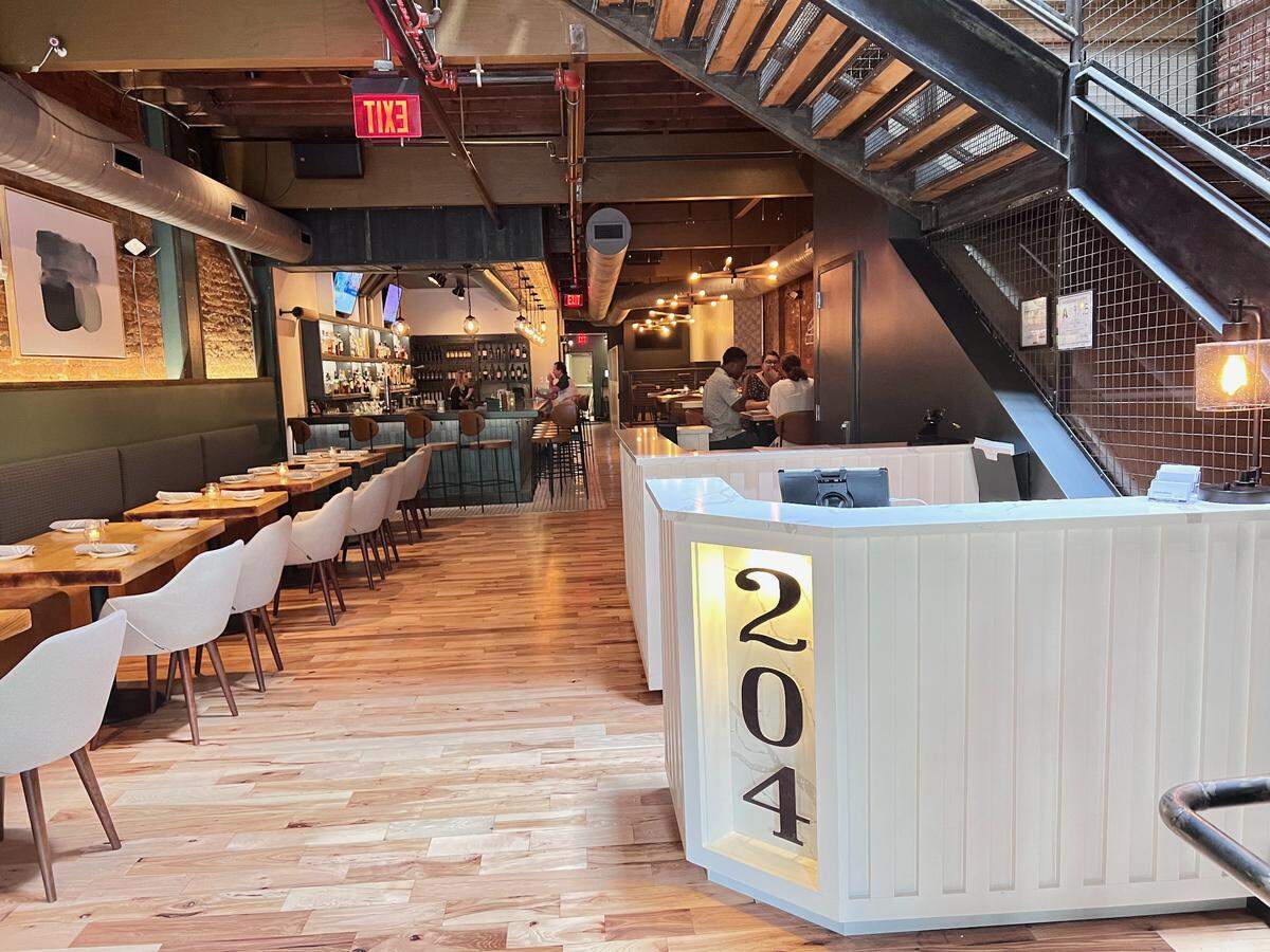 Design updates at 204 North Kitchen and Cocktails highlight exposed brick, beams and wood floors in the space.