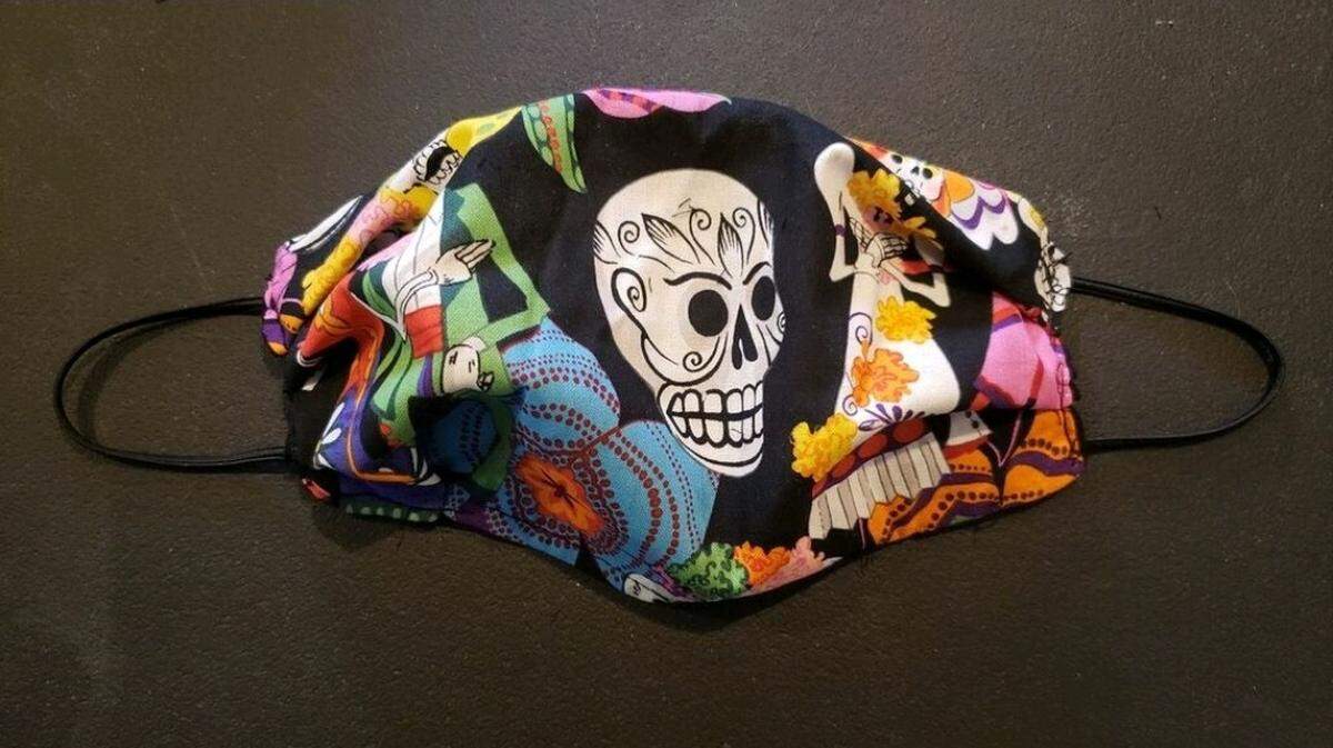 Local makeup artist Kymm McLean sews her own masks with vibrant material, which include a pocket to insert a filter.