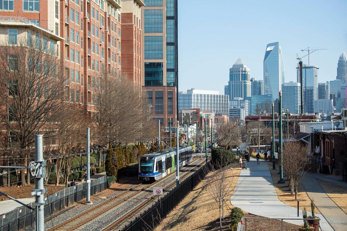 A view of uptown and the light rail as seen from the upper deck of Trolley Barn Fermentory & Food Hall in South End. The neighborhood has seen plenty of development along the light rail since it first opened. Recently, developers have announced a number of high-rise buildings in South End near the light rail stations.