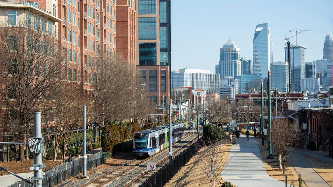 A view of uptown and the light rail as seen from the upper deck of Trolley Barn Fermentory & Food Hall in South End. The neighborhood has seen plenty of development along the light rail since it first opened. Recently, developers have announced a number of high-rise buildings in South End near the light rail stations.