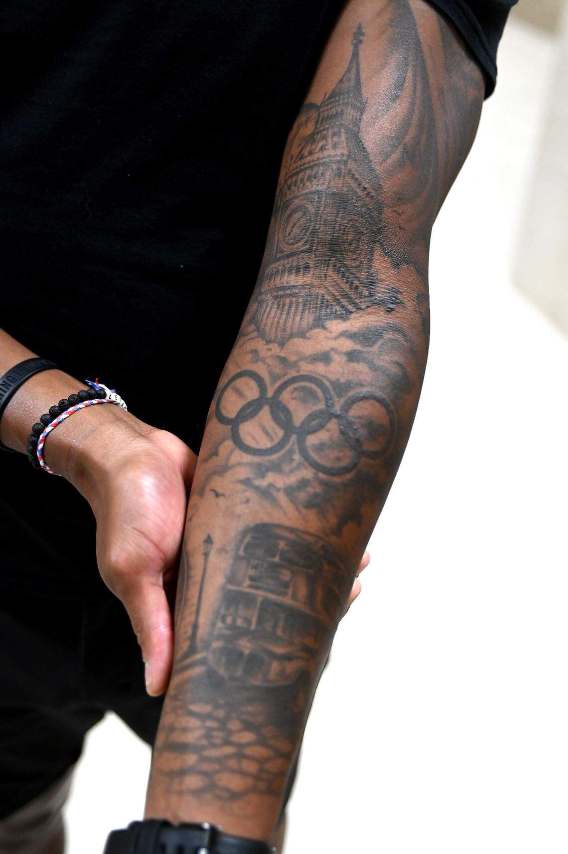 Former Olympic gold medalist swimmer Cullen Jones has tattooed his left arm with scenes from the 2012 London Olympics and the 2008 Beijing Olympics. Jones earned two Olympic gold and two Olympic silver medals and represented Team USA in the Olympics in 2008 and 2012.
