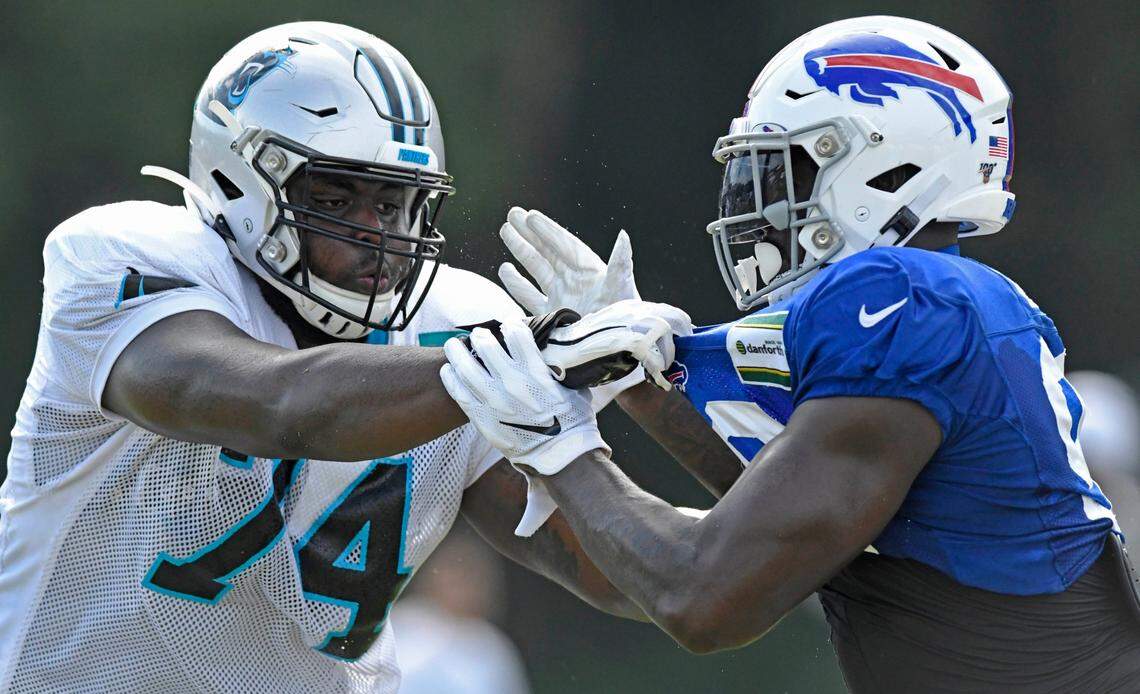 Carolina Panthers offensive tackle Greg Little (74) and Buffalo Bills defensive end Shaq Lawson (90) take on the challenge in a a blocking drill during their joint practice at Wofford College in Spartanburg, SC on Wednesday, August 14, 2019.