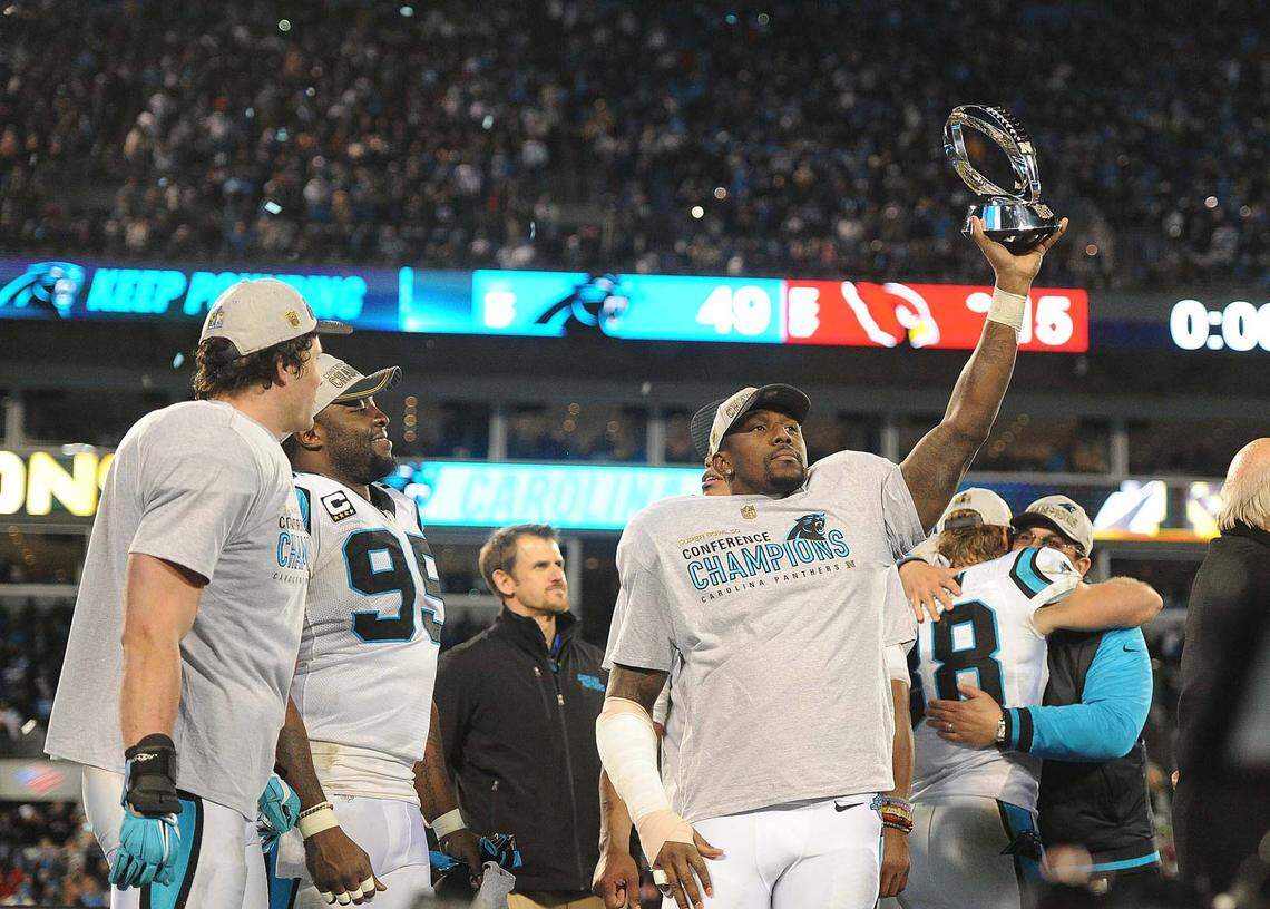 Thomas Davis hoists the NFC Championship trophy following the Panthers’ win over Arizona in January 2016.