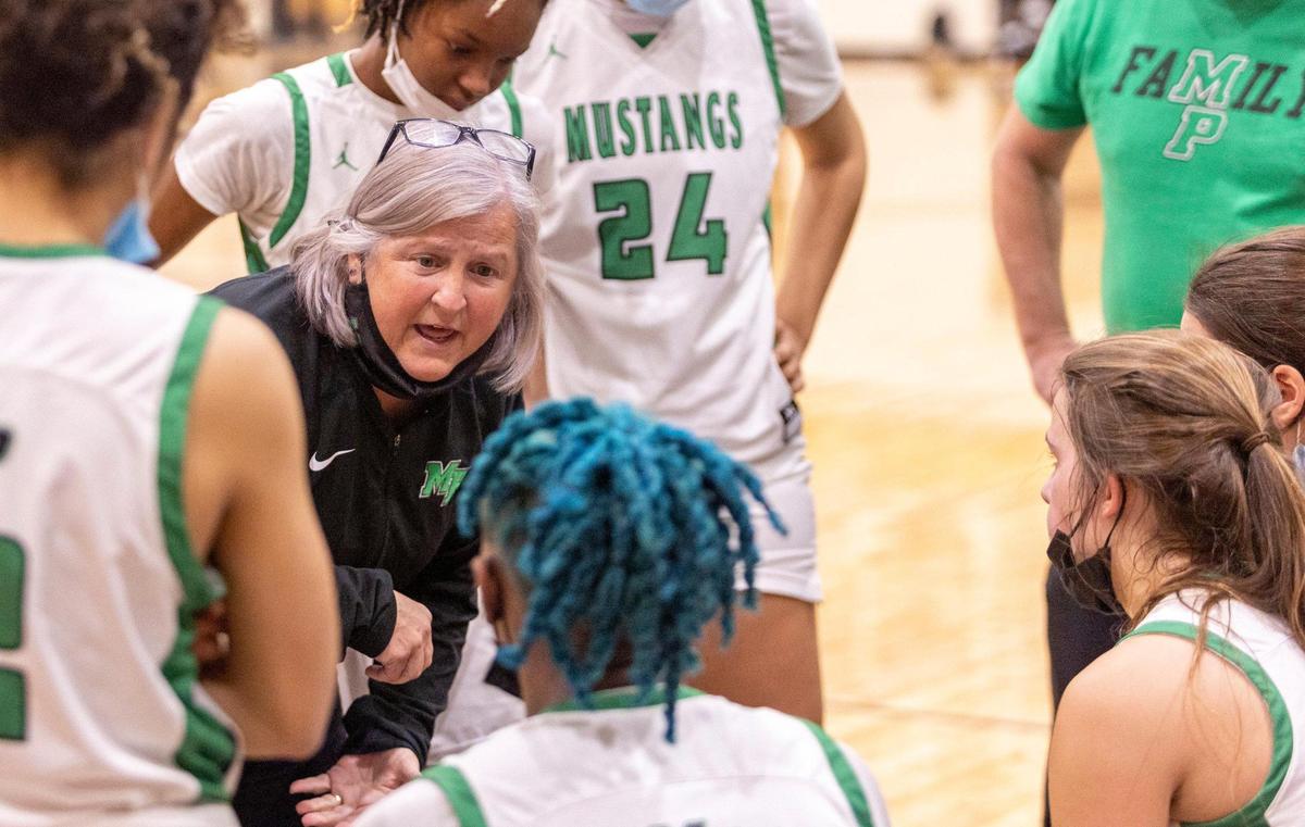 Myers Park head coach Barbara Nelson talks with her team during a timeout at the SoMECK conference tournament championship game against South Meck at Harding High School on Friday, February 18, 2022.