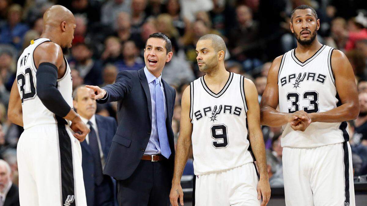 San Antonio Spurs assistant James Borrego (center, in tie) worked with some strong personalities, including Tony Parker (9) and former Charlotte Bobcat Boris Diaw (33).