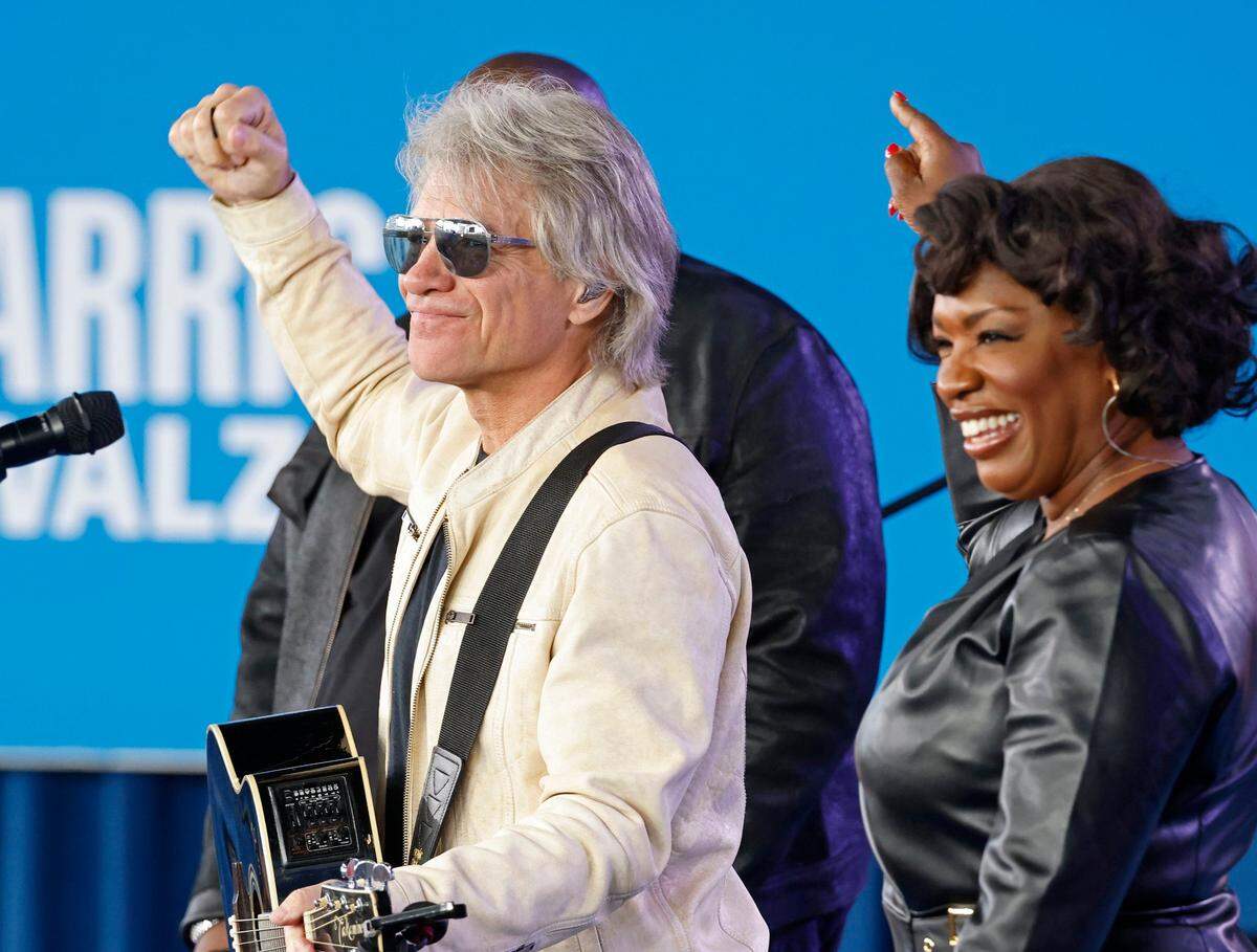 Jon Bon Jovi, left, performs during a “When We Vote We Win” rally for presidential candidate and Vice President Kamala Harris at PNC Music Pavilion on Saturday, November 2, 2024.