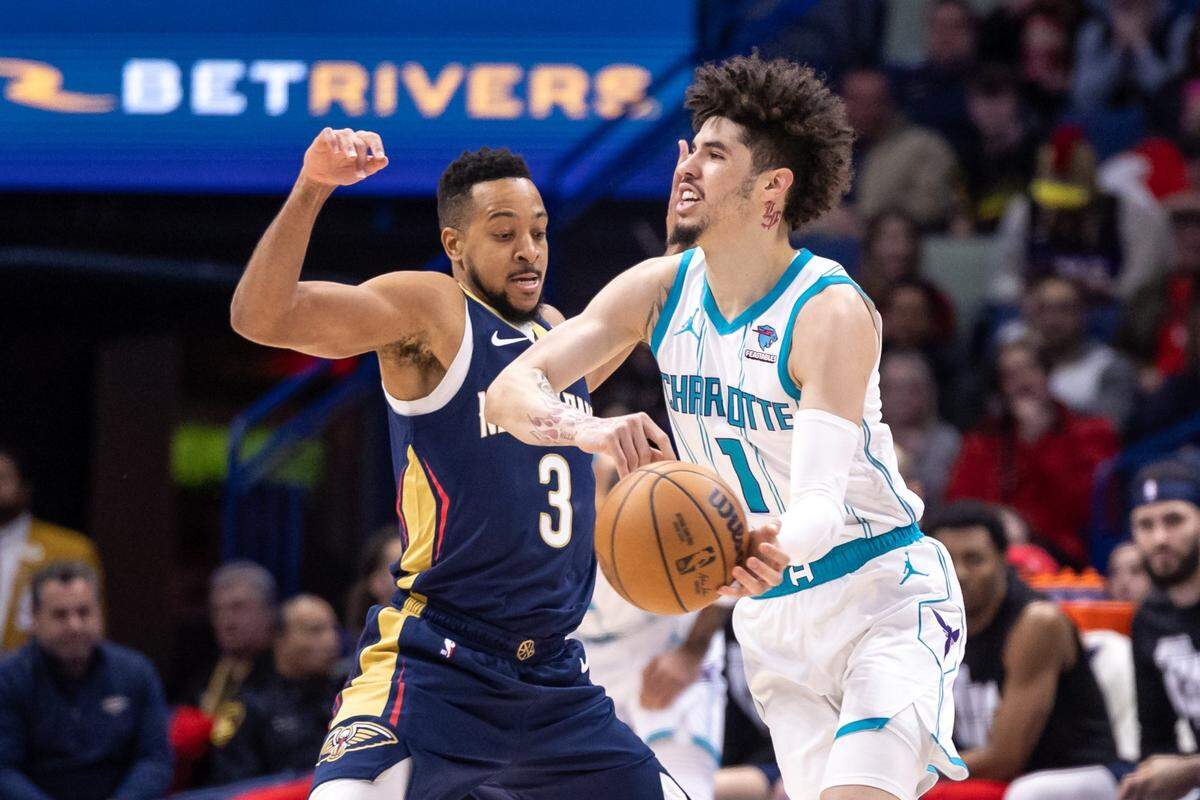 Charlotte Hornets guard LaMelo Ball (1) looks to pass the ball against New Orleans Pelicans guard CJ McCollum (3) during the first half at Smoothie King Center.