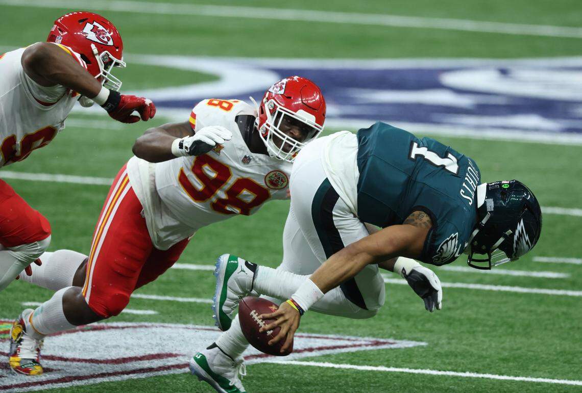 Feb 9, 2025; New Orleans, LA, USA; Philadelphia Eagles quarterback Jalen Hurts (1) is tackled by Kansas City Chiefs defensive tackle Tershawn Wharton (98) in the second quarter in Super Bowl LIX at Ceasars Superdome. Mandatory Credit: Stephen Lew-Imagn Images