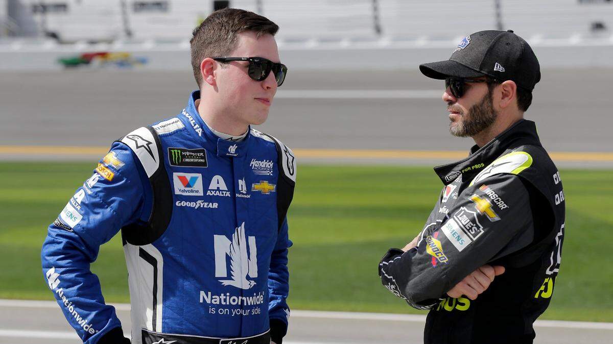 In this Sunday, Feb. 11, 2018, file photo, Alex Bowman, left, and Jimmie Johnson talk on pit road before qualifying for the NASCAR Daytona 500 auto race at Daytona International Speedway, in Daytona Beach, Fla. The most coveted seat in NASCAR went to Alex Bowman in a Hendrick Motorsports lineup shuffle to replace seven-time champion Jimmie Johnson in the iconic No. 48 Chevrolet. Bowman and crew chief Greg Ives will move from the No. 88 into Johnson’s ride at the end of the season. The swap announced Tuesday, Oct. 6, 2020, makes Bowman just the second driver of the team created in 2001 specifically for Johnson. (AP Photo/Terry Renna, File)
