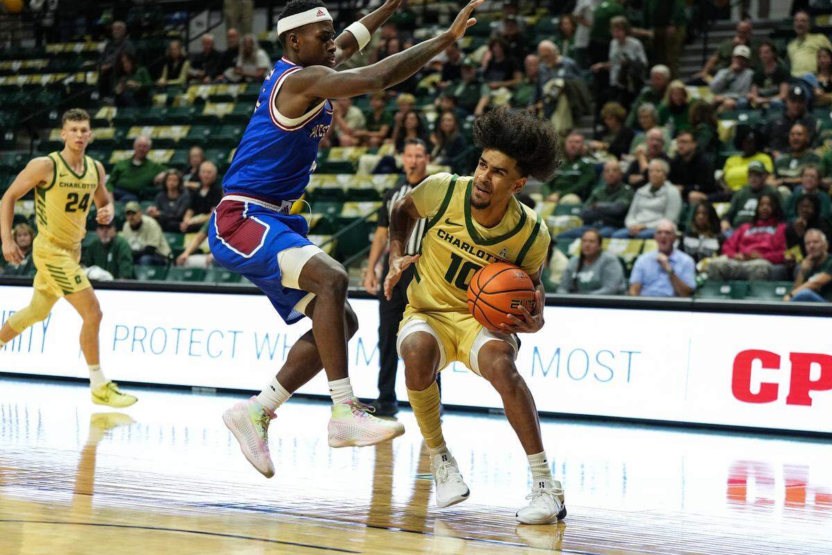 Charlotte guard Nik Graves (10) drives to the basket against Presbyterian guard Kory Mincy during a November game.