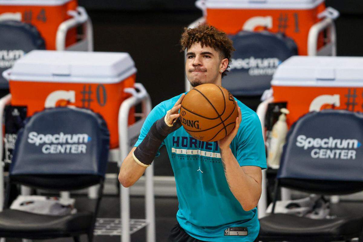 Charlotte Hornets guard LaMelo Ball, wearing a cast on his fractured right wrist, shoots before an NBA basketball game between the Charlotte Hornets and the Atlanta Hawks Sunday. Ball broke his wrist on March 20th, and the Hornets have gone 7-4 without him since then.