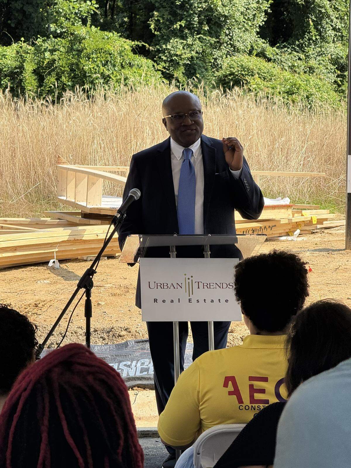 Chris Ogunrinde, the CEO of Urban Trends Real Estate, speaks to a crowd at the groundbreaking for Bishop Madison Homes, an affordable for-sale single-family development.