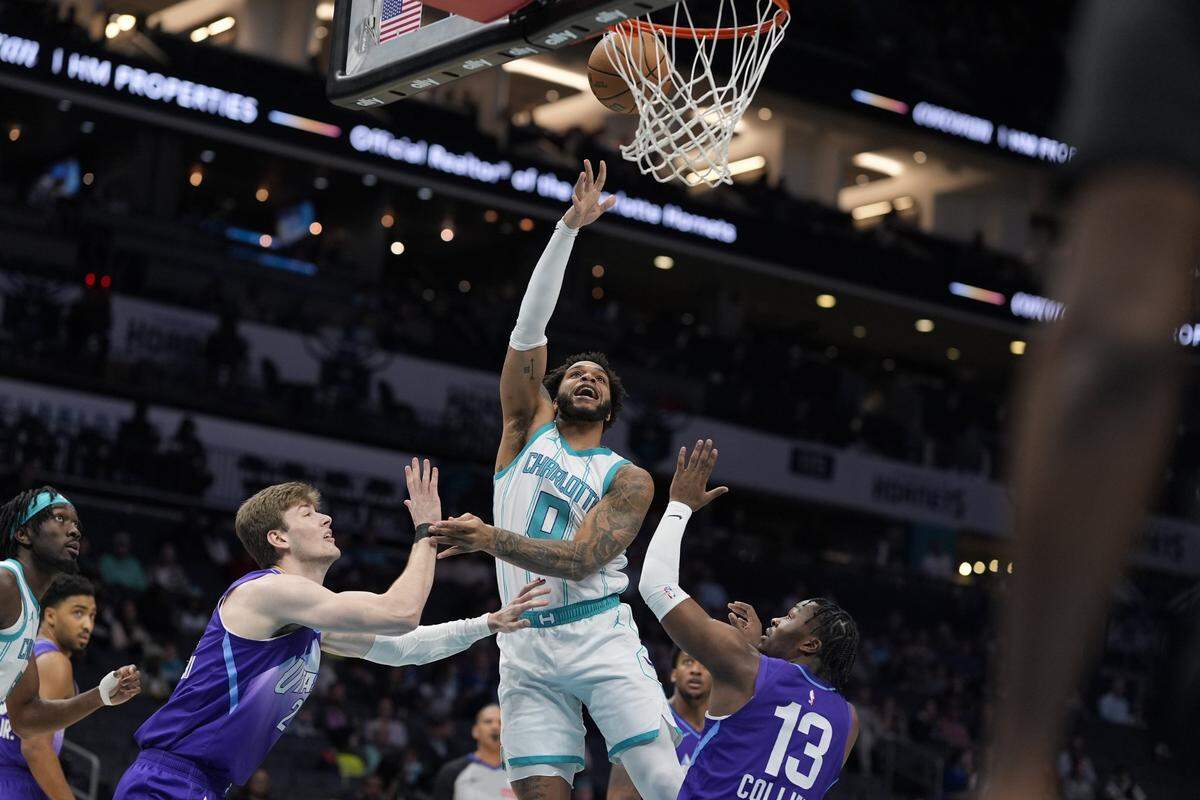 Charlotte Hornets forward Miles Bridges (0) goes to the basket against Utah Jazz forward Kyle Filipowski (22) during the first quarter at Spectrum Center.