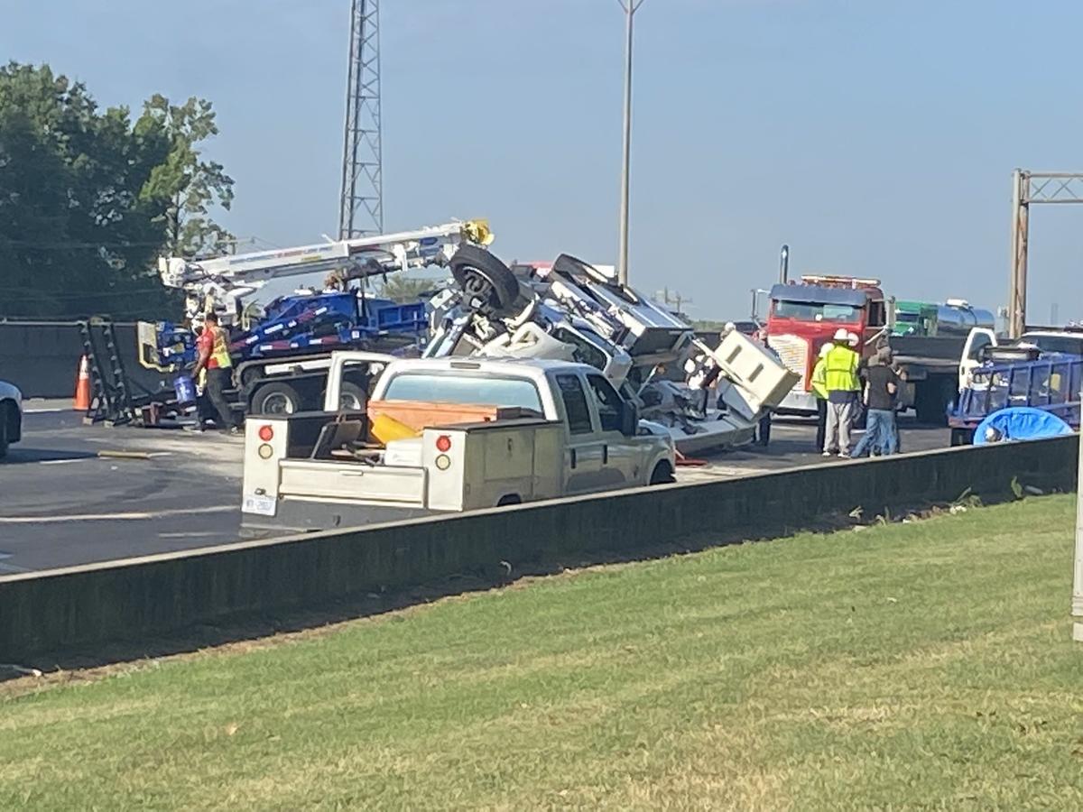 In this image from Observer news partner WSOC, crews work to remove a truck that overturned on Interstate 85 near the Statesville Avenue exit on Friday, Sept. 2, 2022. The wreck closed three southbound lanes.