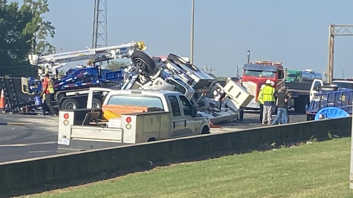 In this image from Observer news partner WSOC, crews work to remove a truck that overturned on Interstate 85 near the Statesville Avenue exit on Friday, Sept. 2, 2022. The wreck closed three southbound lanes.