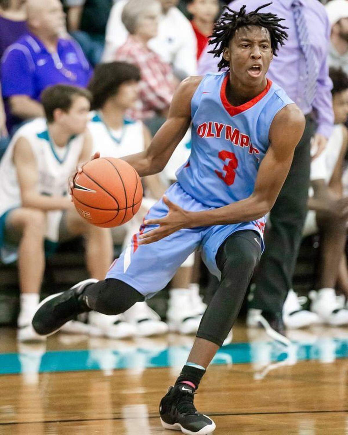 Olympic High’s Josh Banks attacks the basket in Saturday’s game at Concord Cox Mill