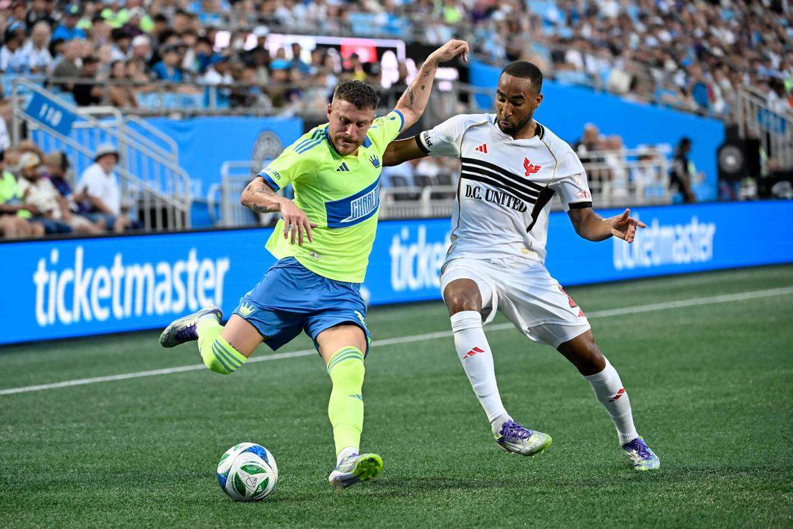 Charlotte FC midfielder Pep Biel (16) with the ball as D.C. United defender Derek Dodson (18) defends during a match earlier this season at Bank of America Stadium.
