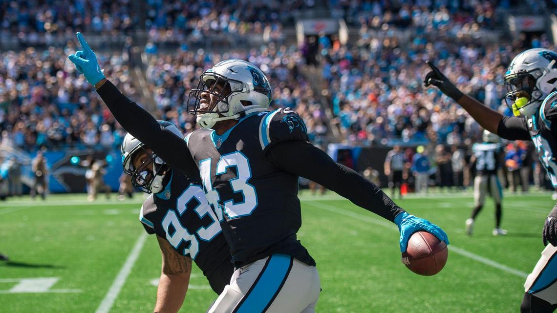 Panthers outside linebacker Haason Reddick points skyward as he runs toward the end zone after intercepting a pass during the game against the Vikings at Bank of America Stadium on Sunday, October 17, 2021 in Charlotte, NC.