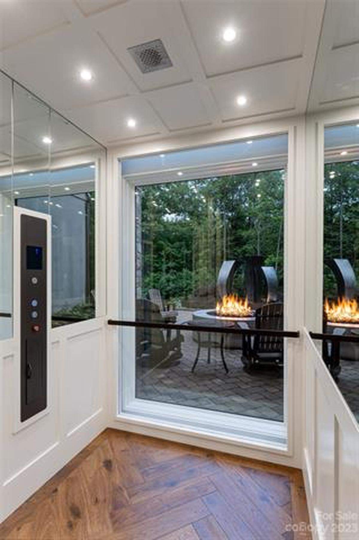 The glass elevator leads to the lower level, with 3-ensuite bedrooms, wet-bar, family room and storage.