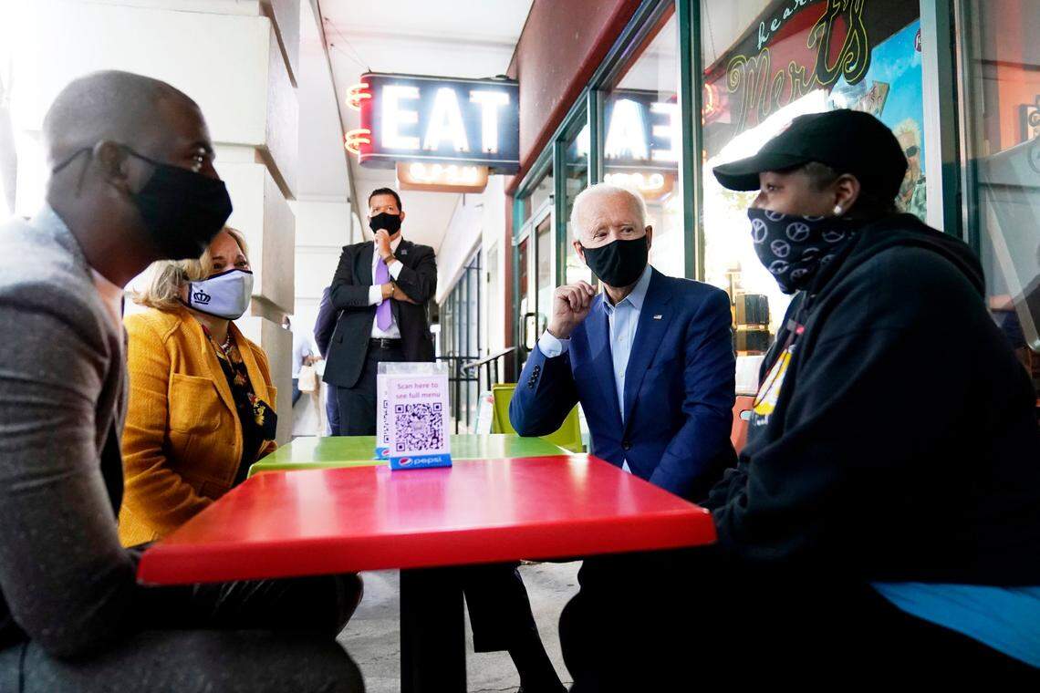 Democratic presidential candidate former Vice President Joe Biden talks with Charlotte, N.C., Mayor Vi Lyles, second from left, NBA player Chris Paul, left, and daughter of the owners of the restaurant, Tia Bozzell, right, at Mert’s Heart & Soul Restaurant in Charlotte, N.C., Wednesday, Sept. 23, 2020.