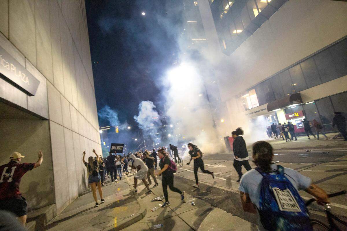 Protesters scramble on 4th Street as police fire chemical agents June 2. The incident could spark a wide-ranging review of police procedures by the city council and public.