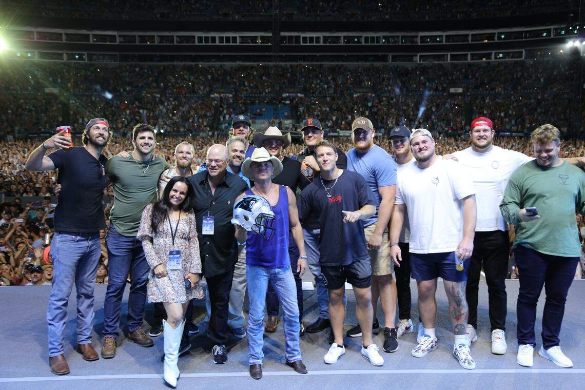 Kenny Chesney with members of the Carolina Panthers organization on stage at his concert on Saturday night.