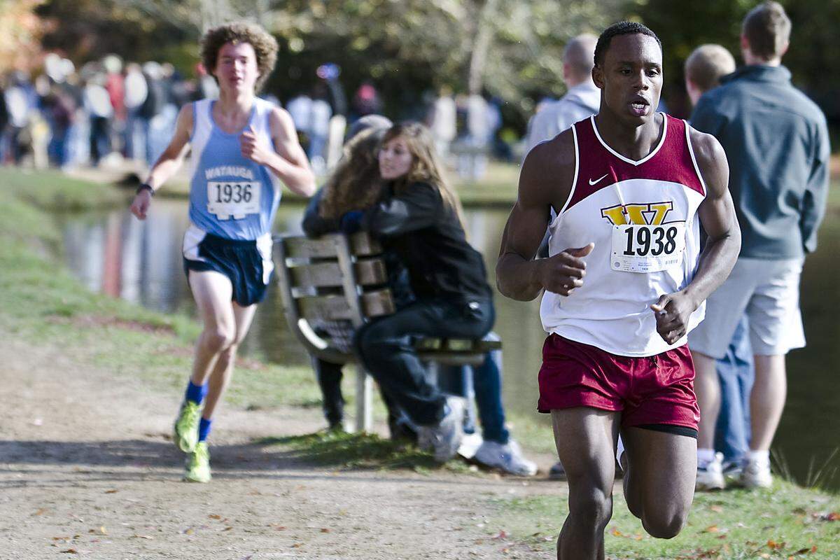 West Charlotte's Mark Blackmon leads Watauga's Peter Vandenburg during the 4A Western Regional cross-country meet at McAlpine Creek Park in 2011.