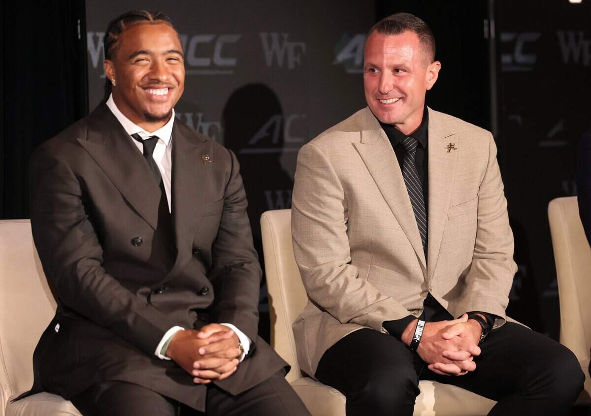 Wake Forest head football coach Jake Dickert, right, laughs along with quarterback Gio Lopez, left, during the 2026 ACC Football Kickoff program at the Charlotte Hilton Uptown hotel in Charlotte, NC on Friday, July 17, 2026.