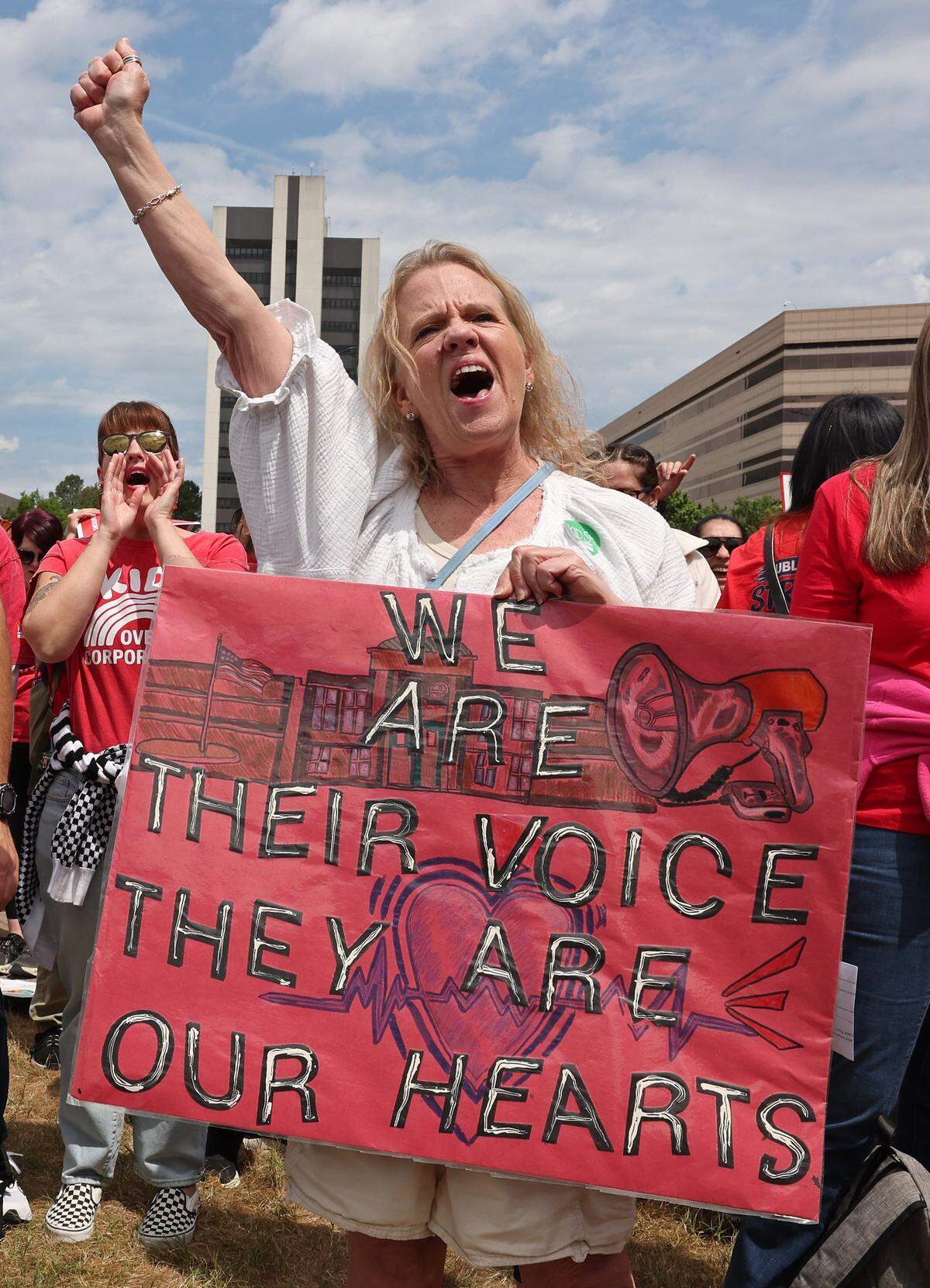 Leslie Highfill, a South Meck High K-12 special needs teacher cheers a speaker during a rally at the Government Complex in Raleigh, NC on Friday, May 1, 2026. Teachers rallied and marched through downtown Raleigh, NC to protest the need for more funding for public schools.