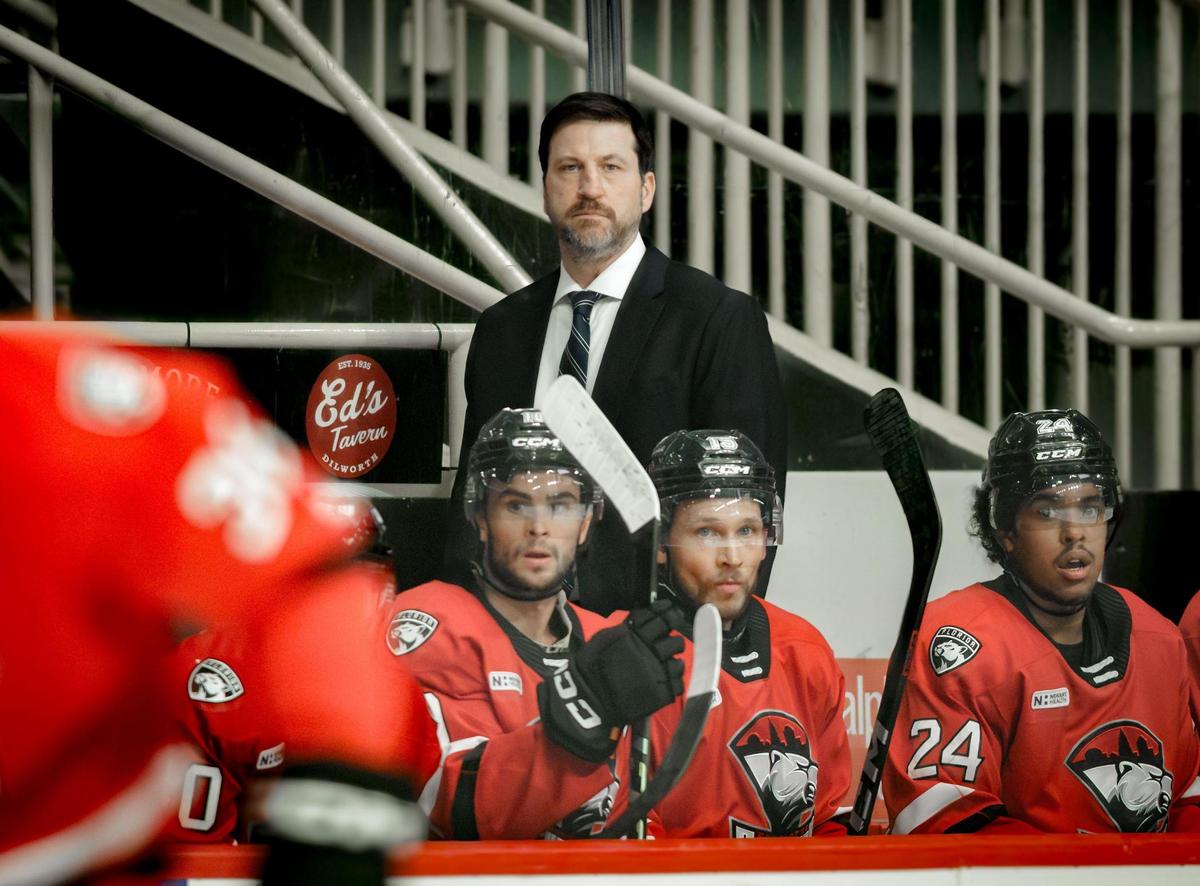 Charlotte Checkers head coach Geordie Kinnear (center) looks on as his team faces the Hershey Bears in the AHL’s Atlantic Division finals at Bojangles Coliseum.
