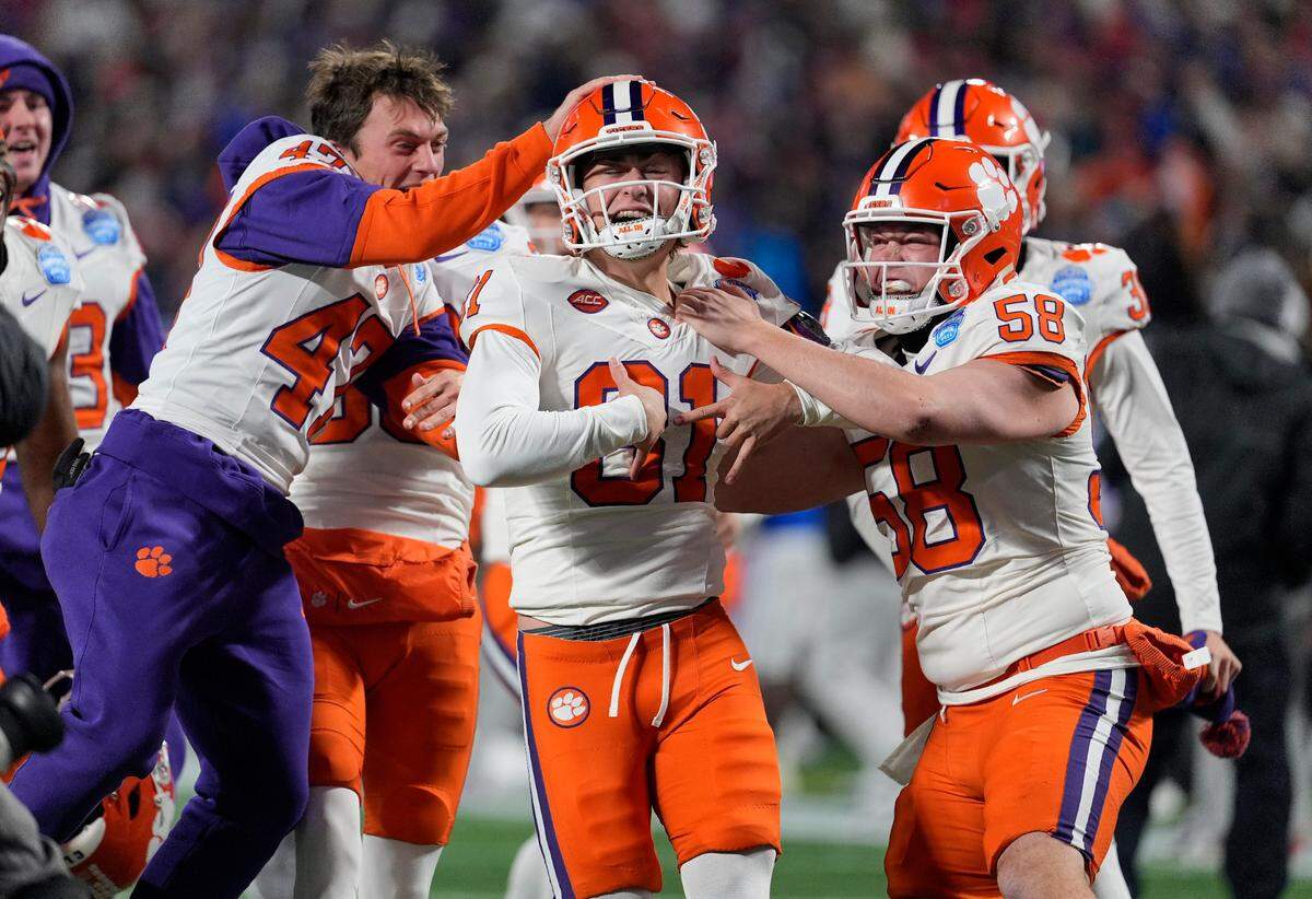 Clemson Tigers kicker Nolan Hauser (81) celebrates with teammates after making a 56-yard field goal as time expired in the fourth quarter to win Saturday’s 2024 ACC Championship game, 34-31, against the SMU Mustangs at Bank of America Stadium.