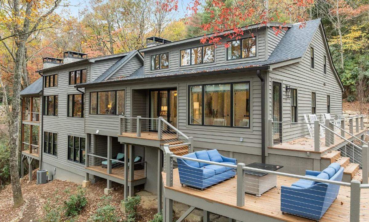 The property includes about 150 feet of waterfront access through landscaped paths to a dock.