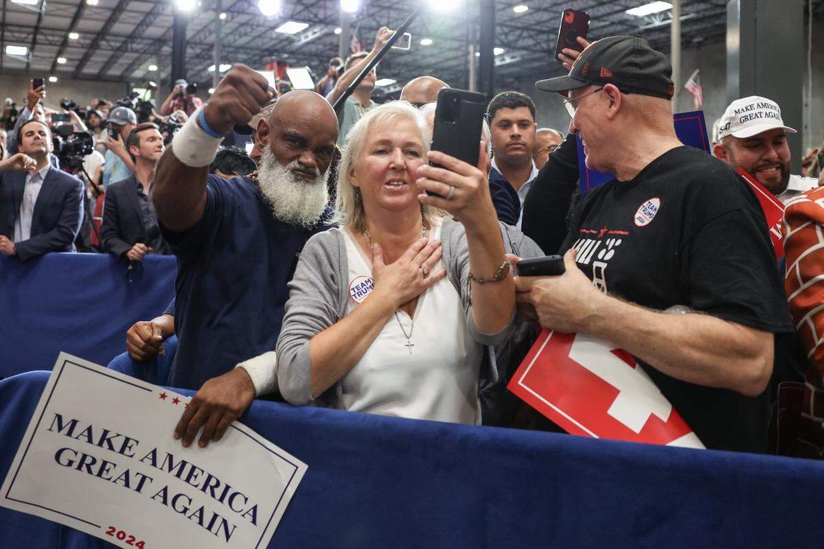 Supporters watch as Former President Donald Trump leaves a campaign rally inside the Mosack Group manufacturing warehouse in Mint Hill, NC on Wednesday, September 25, 2024.